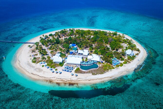 Malamala Beach Club - Half Day Pass - White sand, clear water, and a compact island